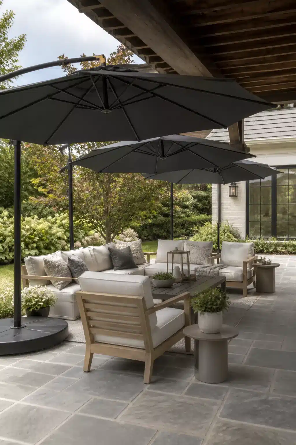 Charcoal cantilever umbrella patio shade ideas over teak outdoor seating on gray limestone pavers