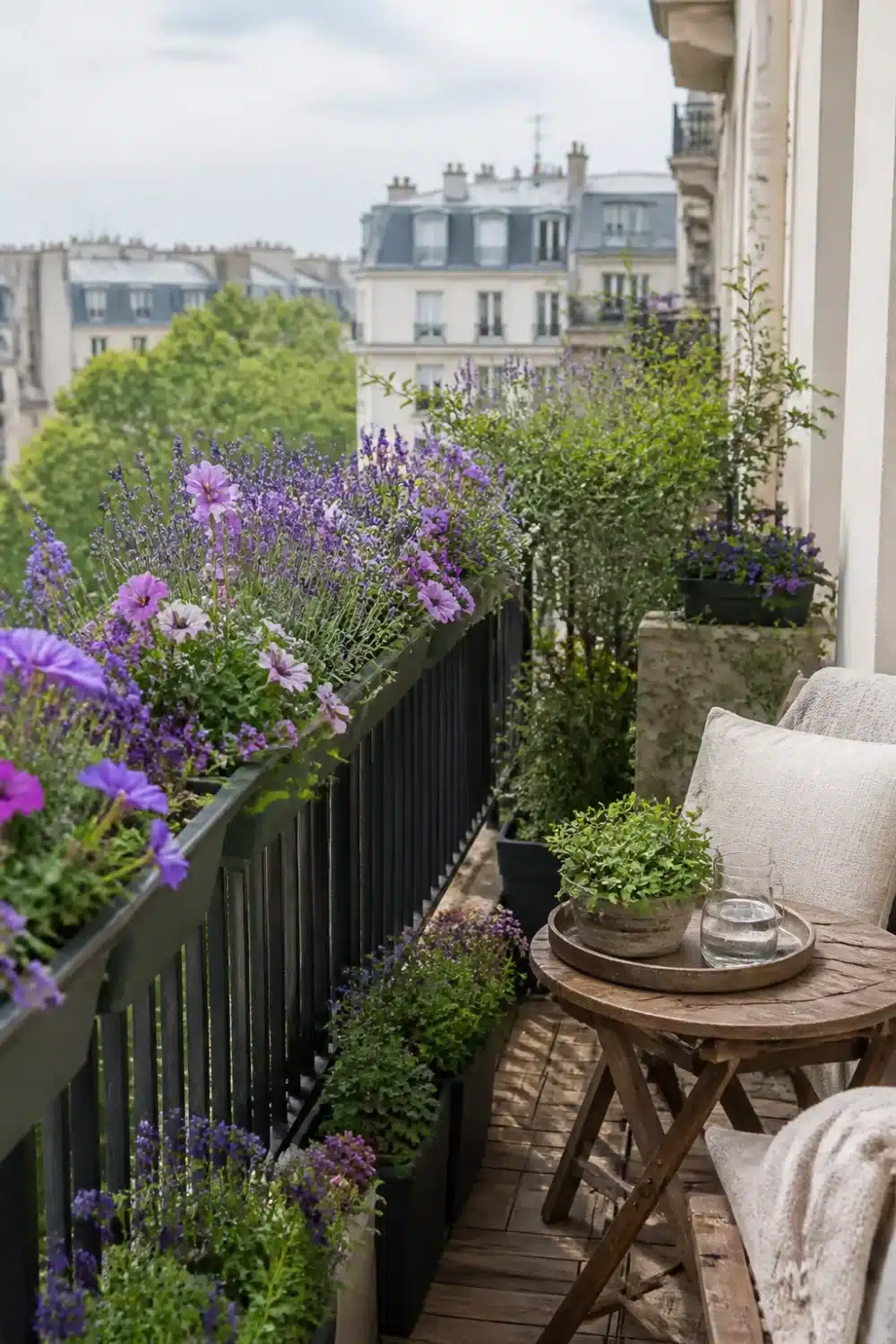 Balcony pollinator garden design with purple lavender and pink geraniums in dark railing planters, Paris