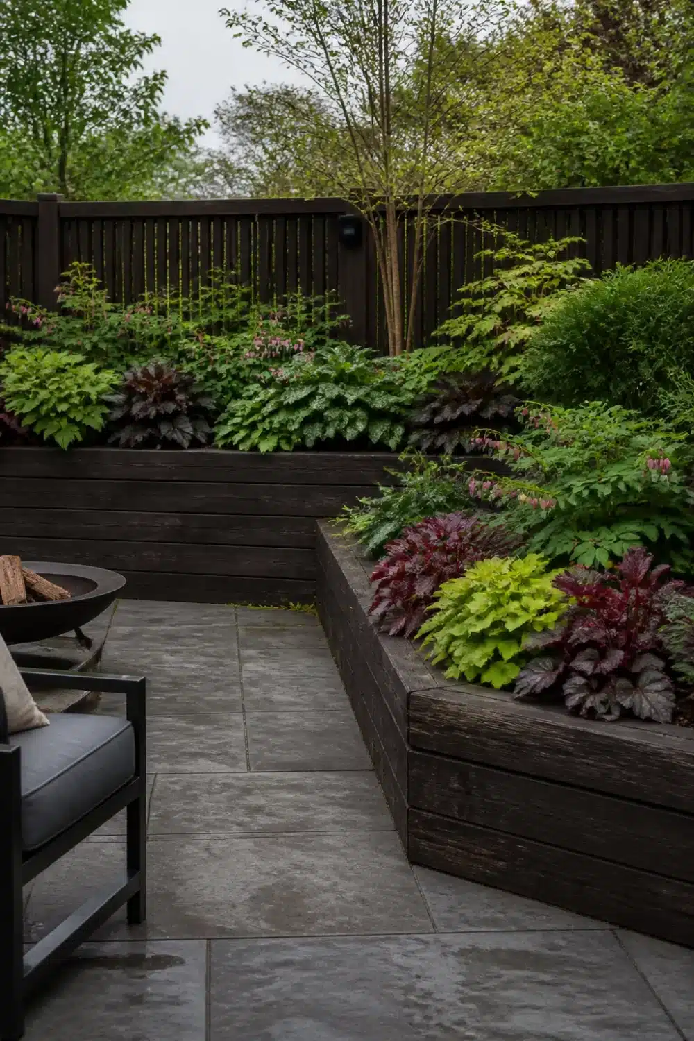 Shade garden design layout with dark timber raised beds, heuchera mix, and gray paver patio.