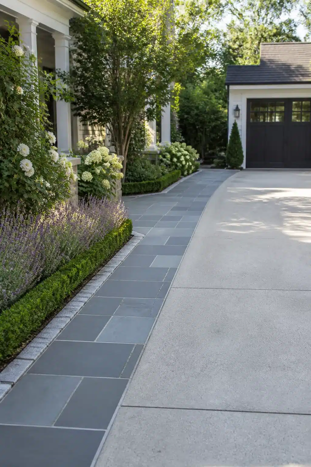 Widen driveway idea using bluestone slab strip with granite cobble edging alongside concrete, colonial home