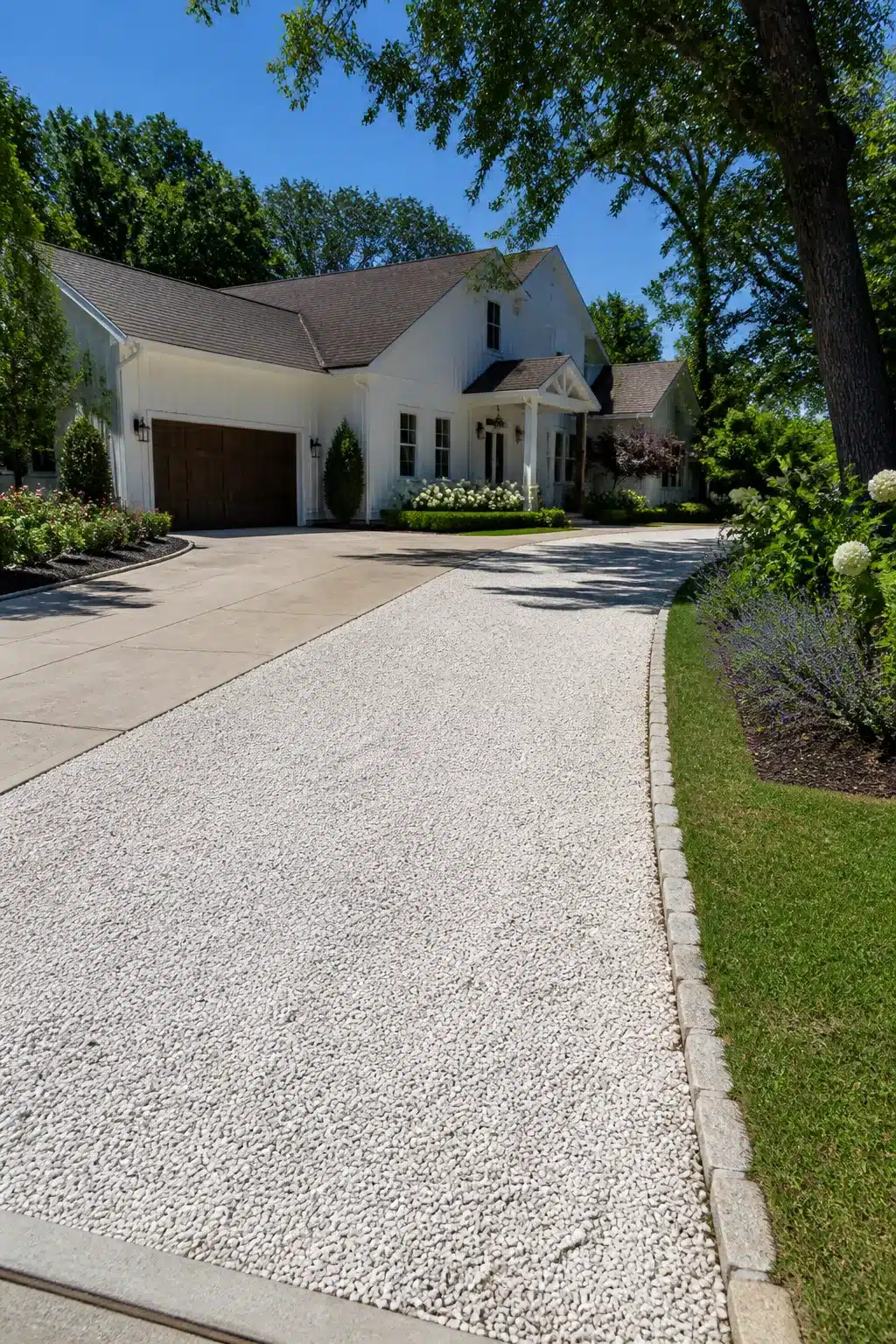 White crushed limestone side lane widen driveway idea with stone edging beside white farmhouse