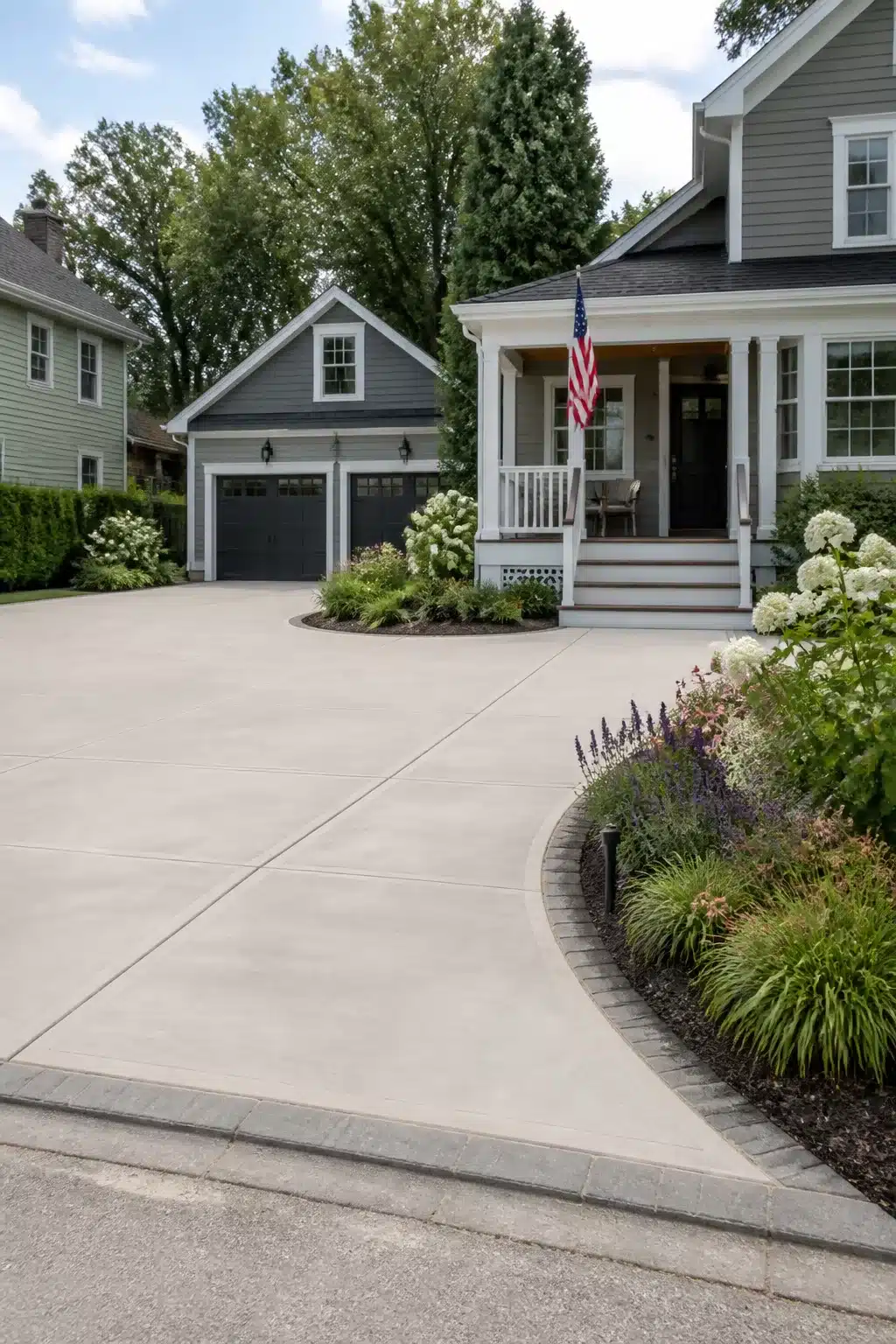 Wide concrete curved flare driveway with planted bed edging — widen driveway ideas for curb appeal